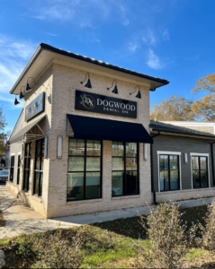 Exterior shot of brick building where people can get cosmetic dentistry in Waxhaw with sign saying 'Dogwood Dental Spa' on the front and side of building above the windows